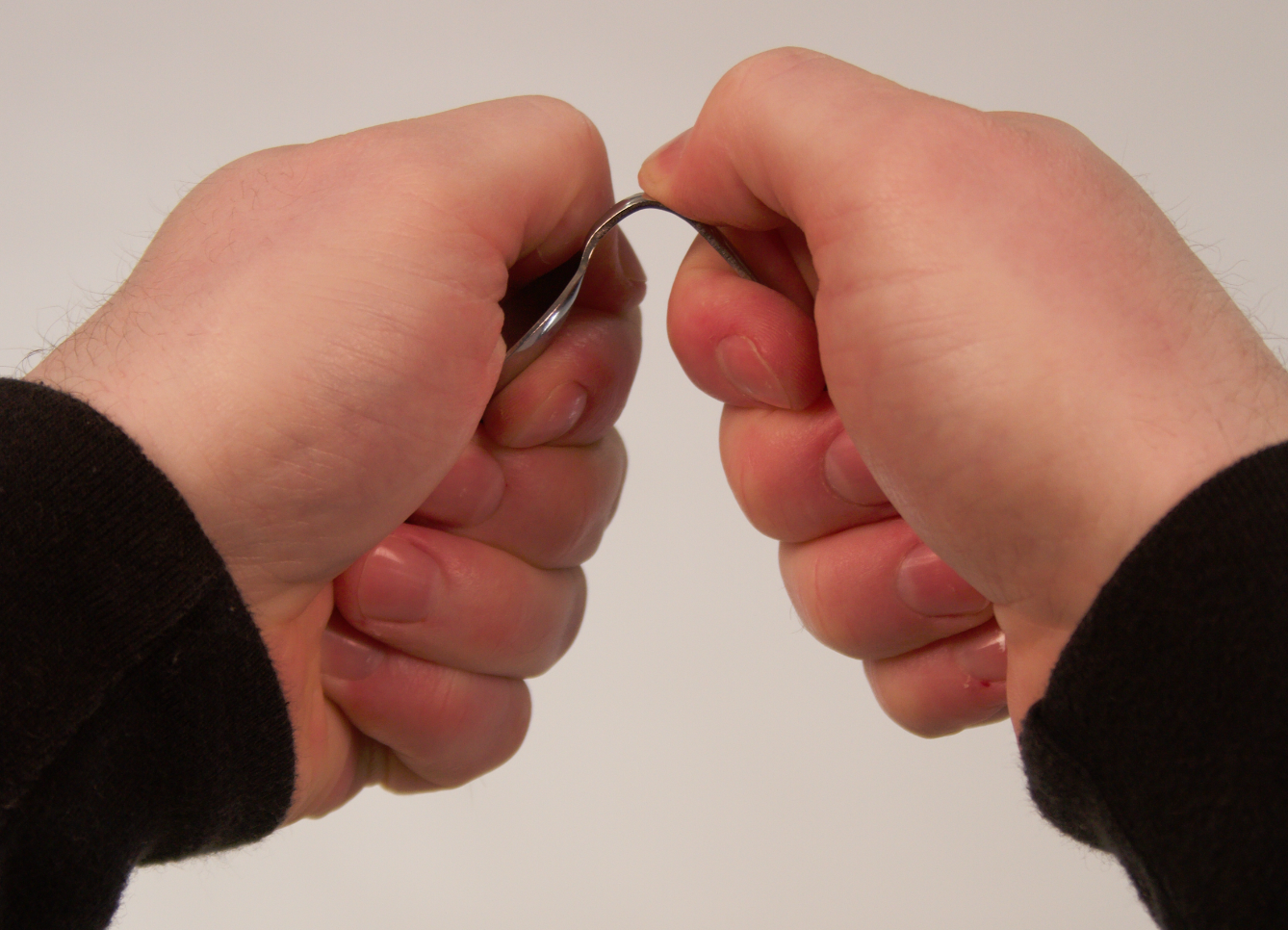 Mentalist preparing a spoon (scoring it and weakening the metal) before a performance